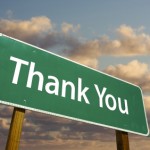 Thank You Green Road Sign with dramatic clouds and sky.